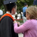 Mother helps son on graduation day