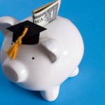 Piggy bank with a graduation cap with dollar bill